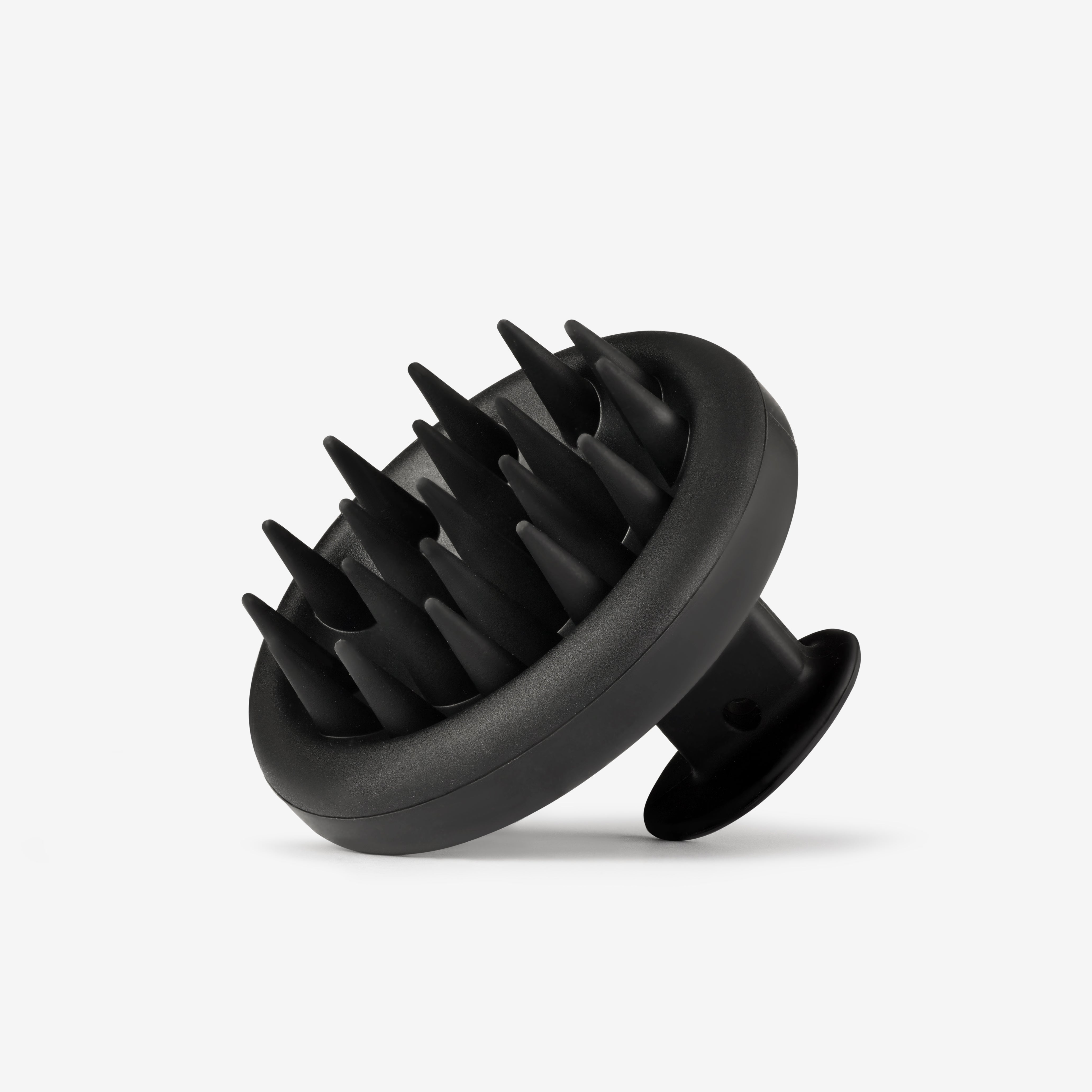Black scalp massager on a white background