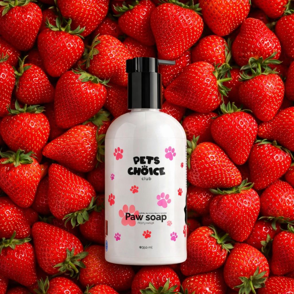 Paw soap bottle with pink paw prints on a background of strawberries