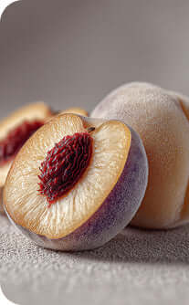 Close-up of a sliced peach with a whole peach on a gray background
