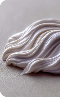 Close-up of white cream on a gray background