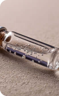 Glass bottle with a message inside on a sandy surface