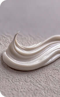 White cream or soap bar on a textured gray surface