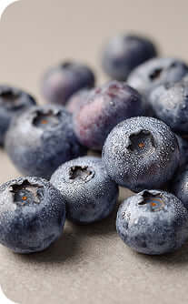 Close-up of frozen blueberries on a textured surface