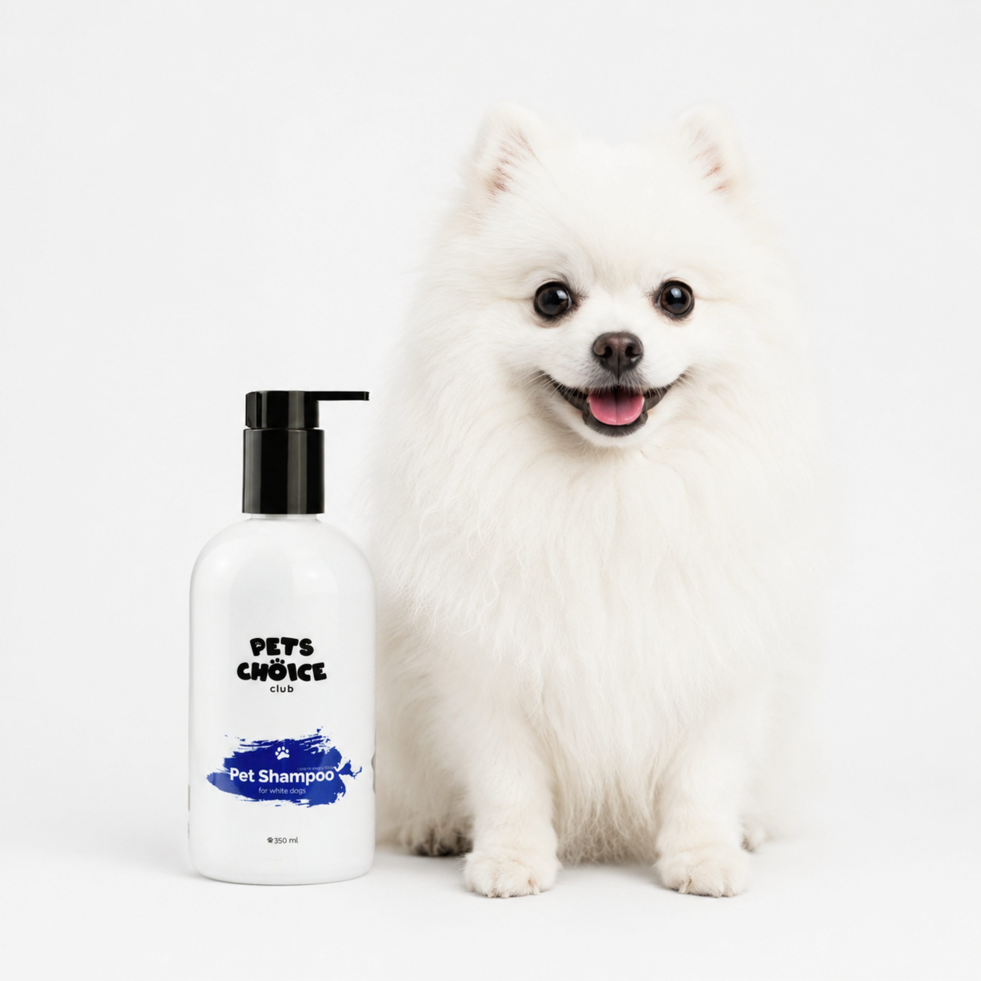 A white fluffy dog sits next to a white bottle of Pets Choice Clean Pet Shampoo with a black pump and blue label details, on a clean white background.