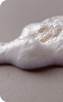 Close-up of white foam on a gray surface