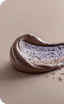 Close-up of chocolate frosting on a beige background