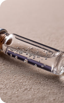 Glass bottle with a message inside on a sandy surface